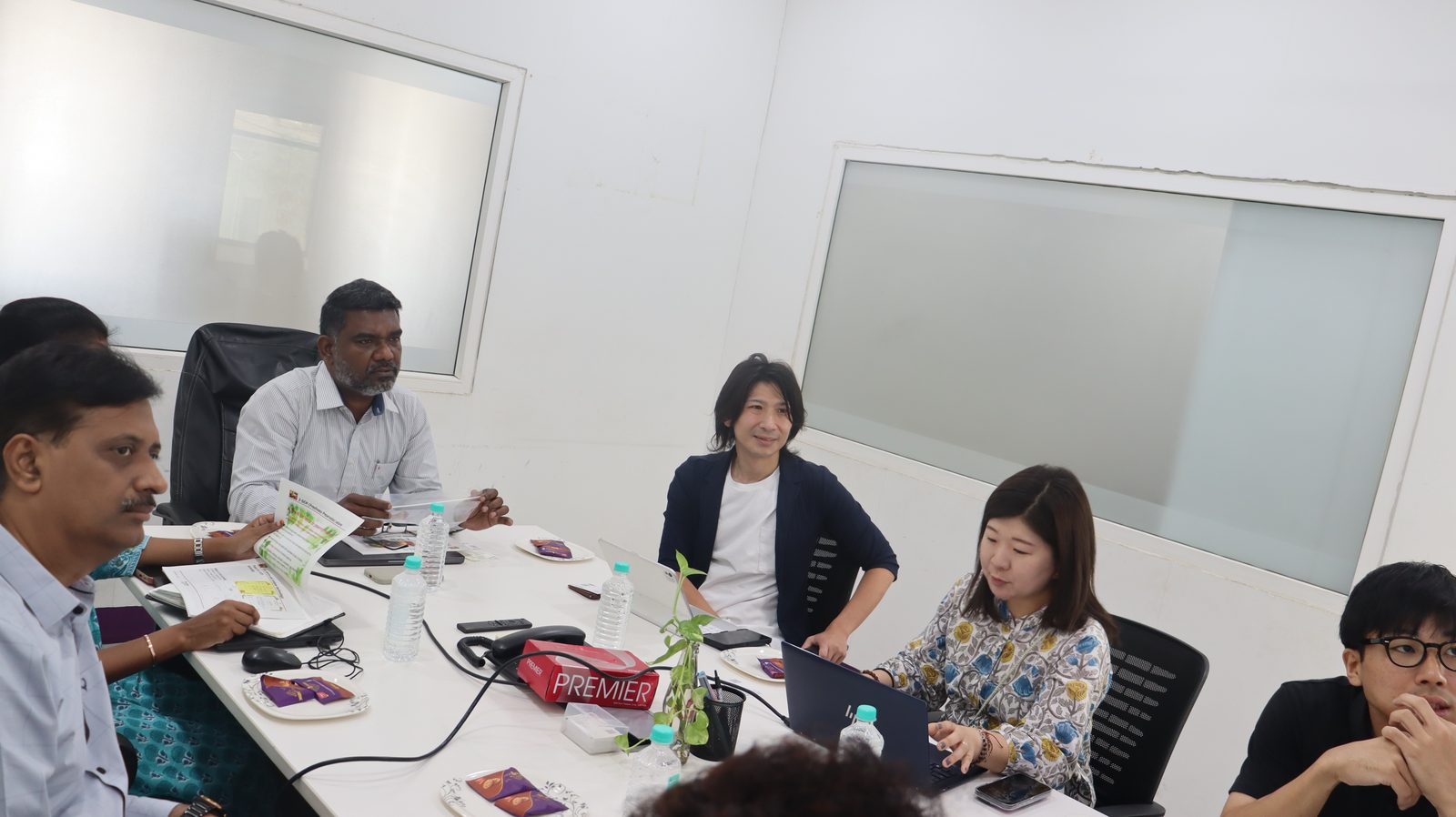 Guires Research Labs leadership and the Japanese delegation in discussion around the boardroom table
